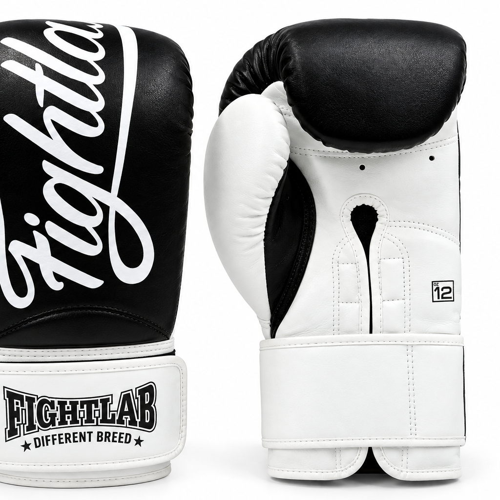 A pair of Fightlab boxing gloves shown from the front and back on a clean white background. The gloves are black and white with the brand name 'Fightlab' printed in white script on the black front glove and on the white wrist strap.