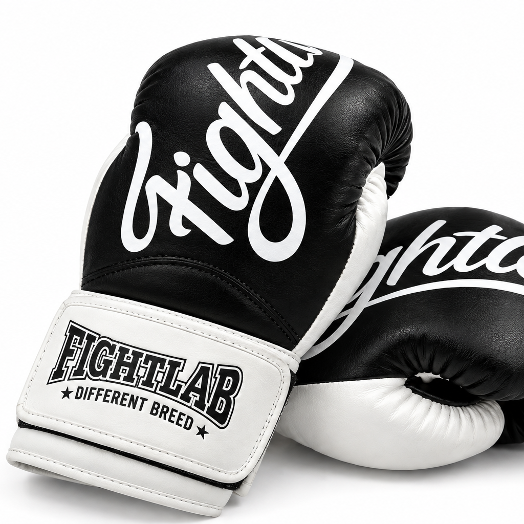 A pair of black and white Fightlab boxing gloves on a clean white background, featuring the brand name 'Fightclab' in white script on the black leather and 'FIGHTLAB' on the white wrist strap.