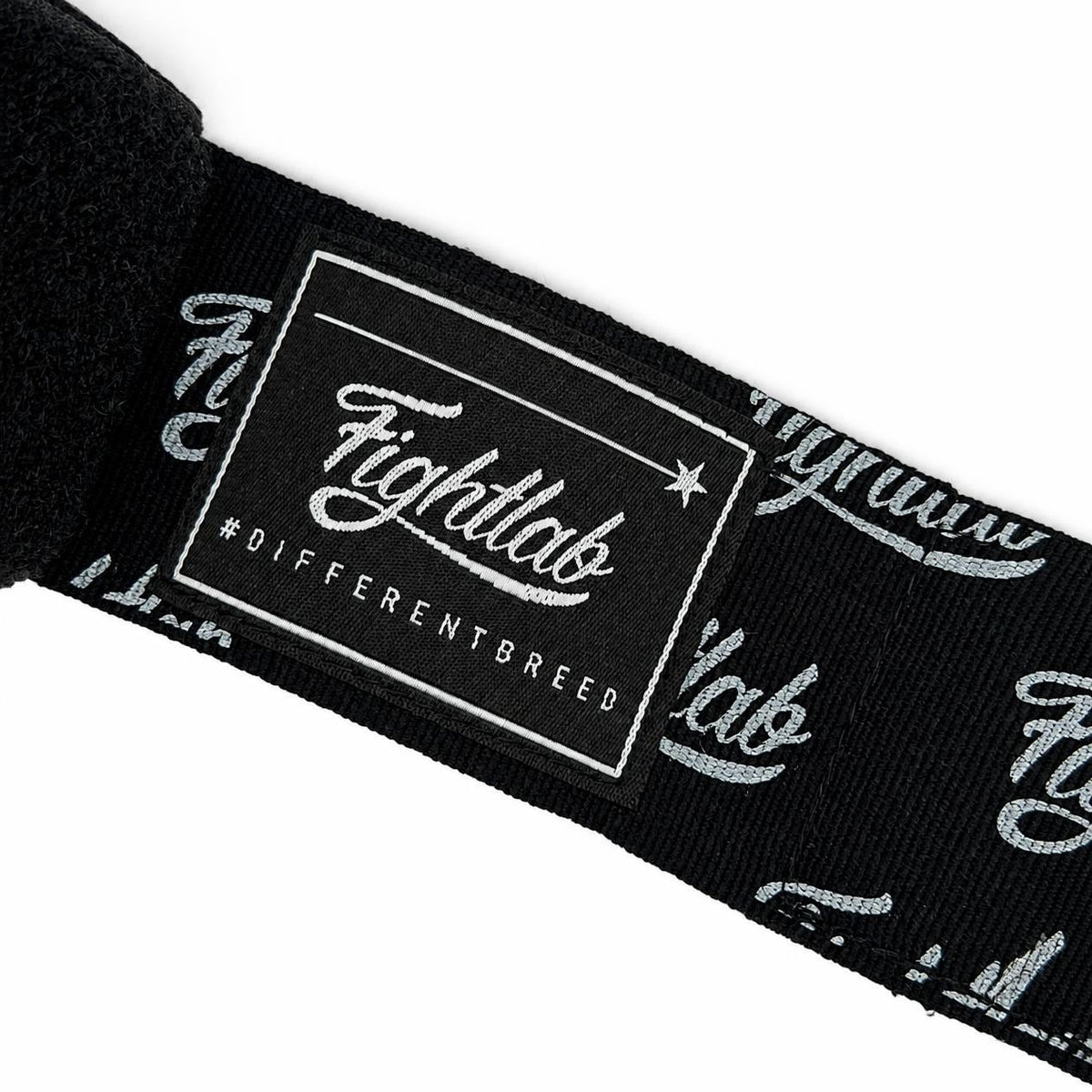 A close-up of a black Fightlat brand strap featuring a white embroidered logo patch and script lettering, set against a plain white background.