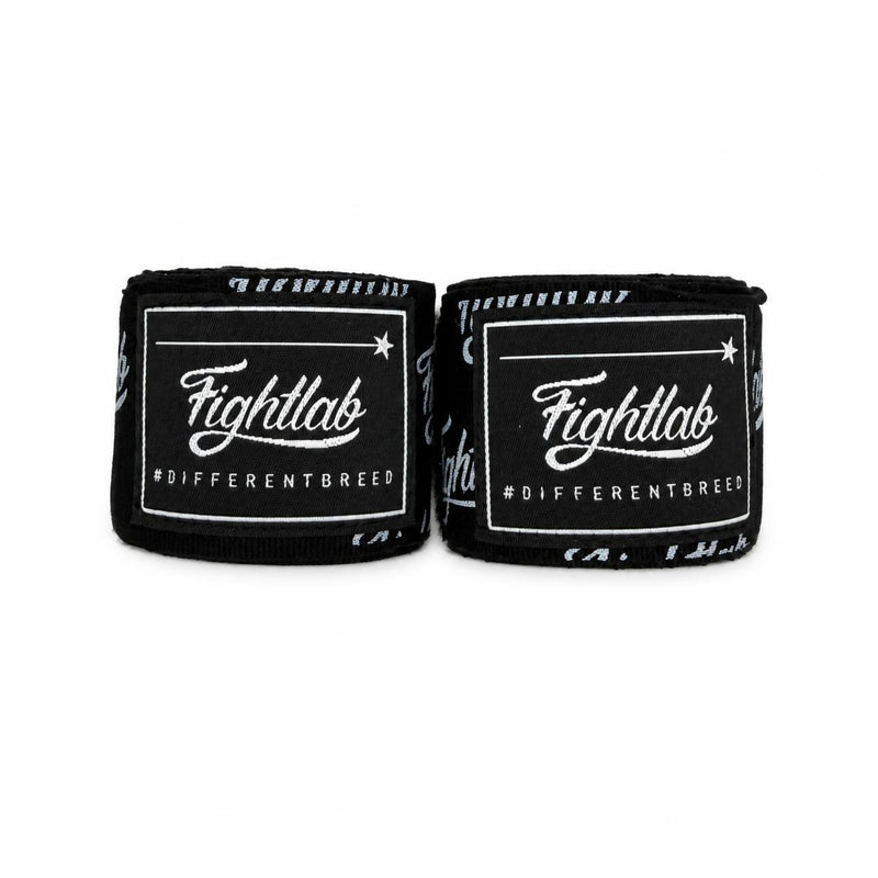 Two black Fightlab wrist wraps with white branding and text, displayed side-by-side on a plain white background.