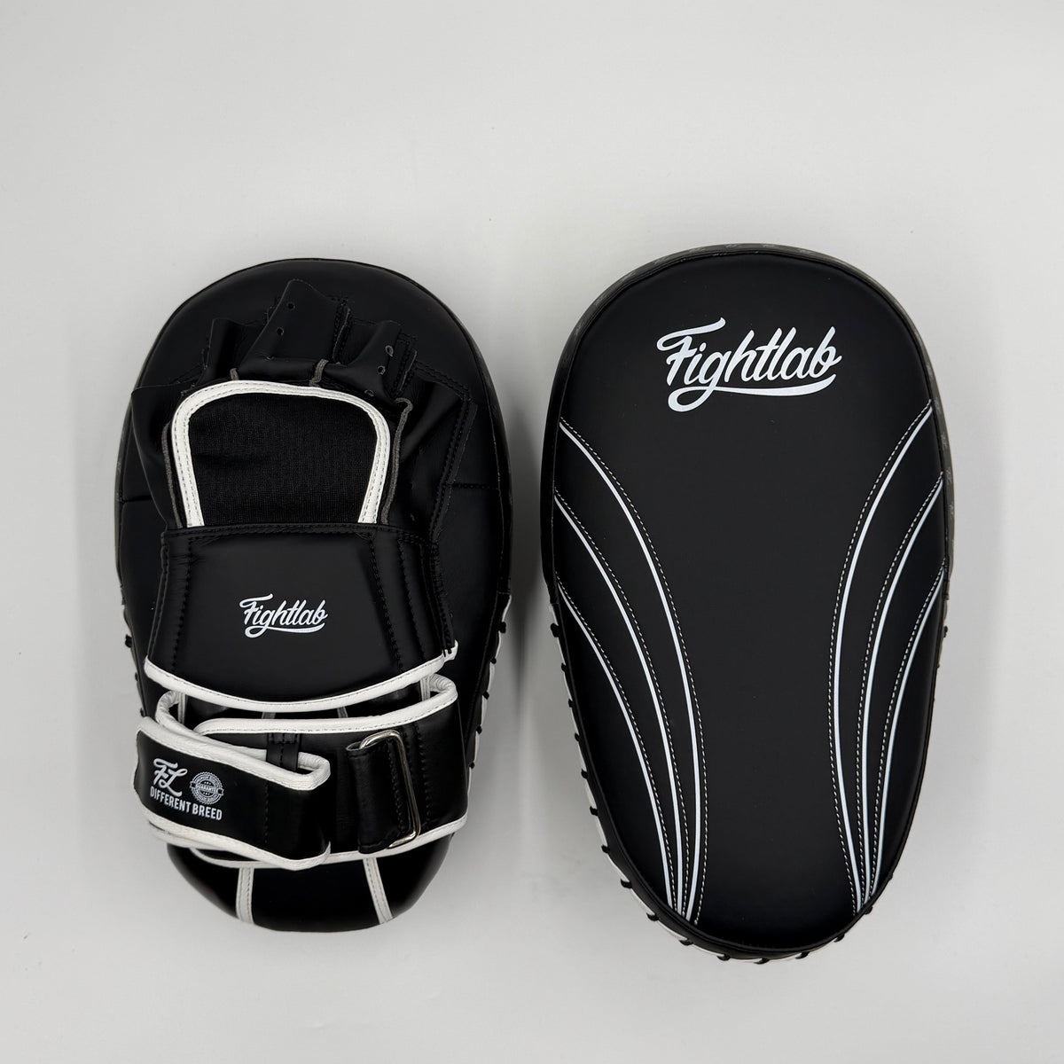 Front and back of Fightlab Edge Solo Thai pads showing arm straps and Fightlab logo