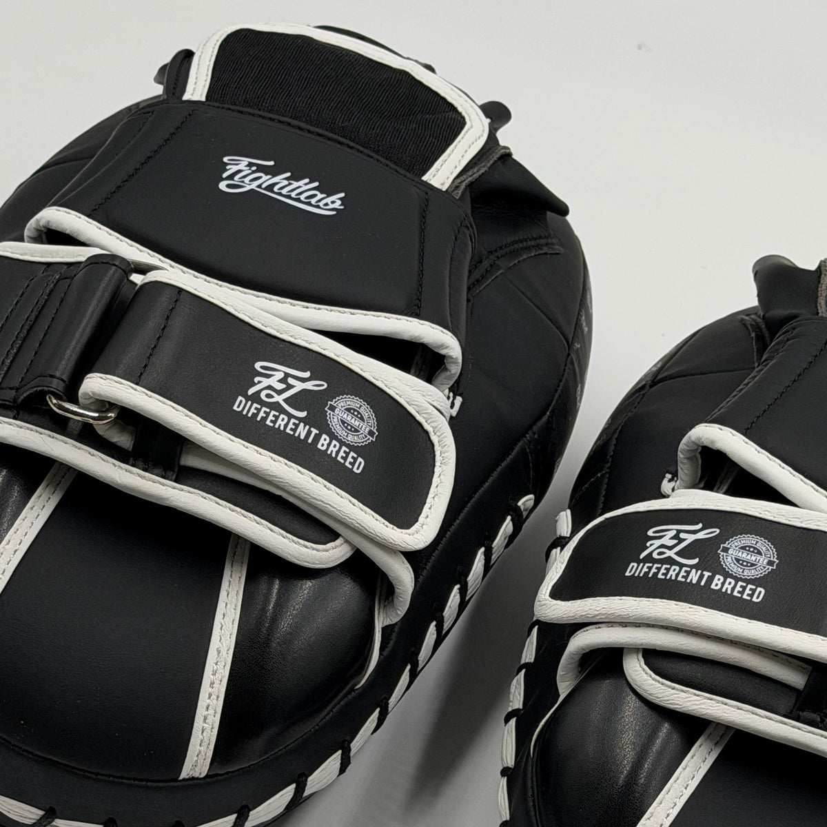Fightlab Edge Solo Thai pads in black and white with Different Breed logo