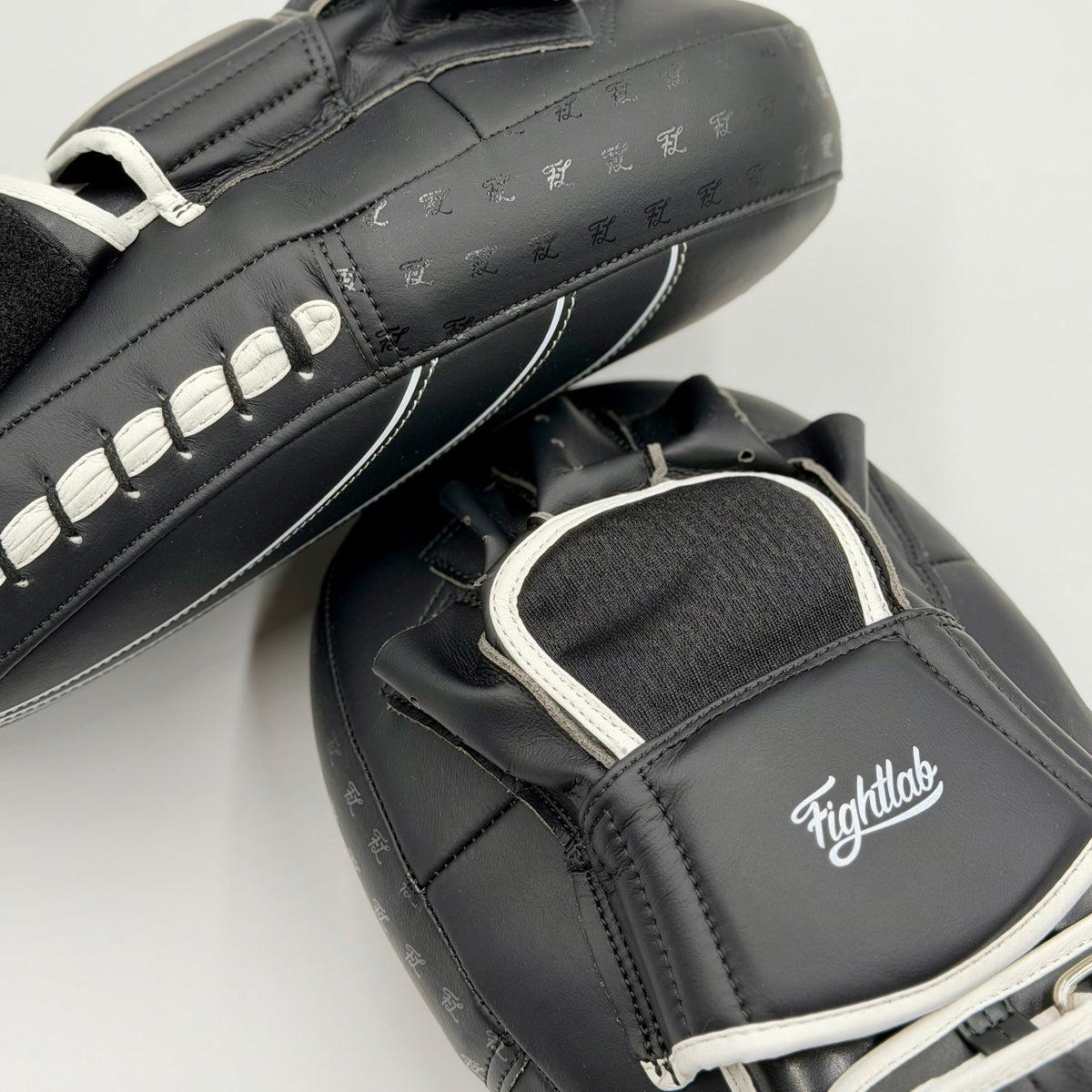 Pair of Fightlab Edge Solo Thai pads with white contrast stitching